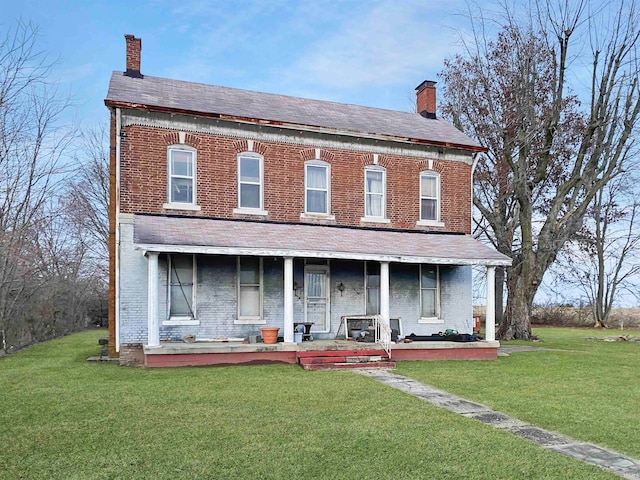 view of front of house with covered porch and a front yard