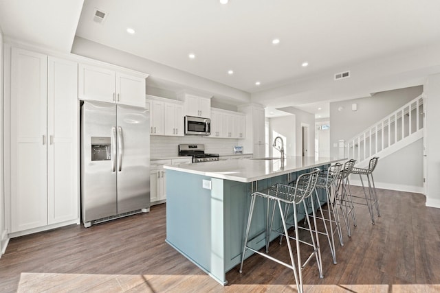 51 Ln 345 Crooked Lk, Angola, IN 46703 - kitchen with white cabinets, tasteful backsplash, hardwood / wood-style flooring, stainless steel appliances, and a large island