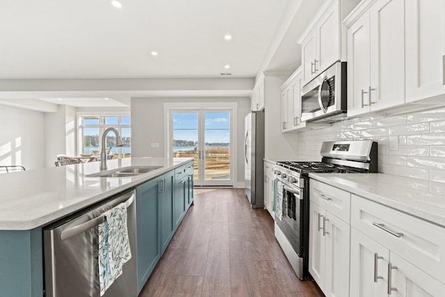 15 Ln 345 Crooked Lk, Angola, IN 46703 - kitchen with appliances with stainless steel finishes, dark hardwood / wood-style floors, tasteful backsplash, a kitchen island with sink, and white cabinetry