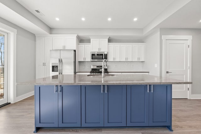 19 Ln 345 Crooked Lk, Angola, IN 46703 - kitchen with a large island with sink, stainless steel appliances, and light wood-type flooring