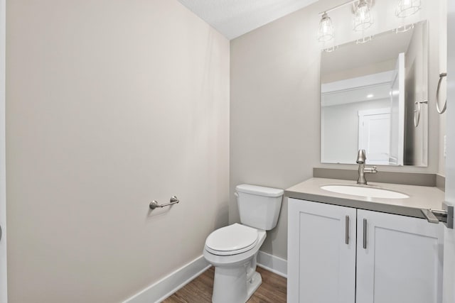 19 Ln 345 Crooked Lk, Angola, IN 46703 - bathroom featuring vanity with extensive cabinet space, a textured ceiling, toilet, and hardwood / wood-style floors