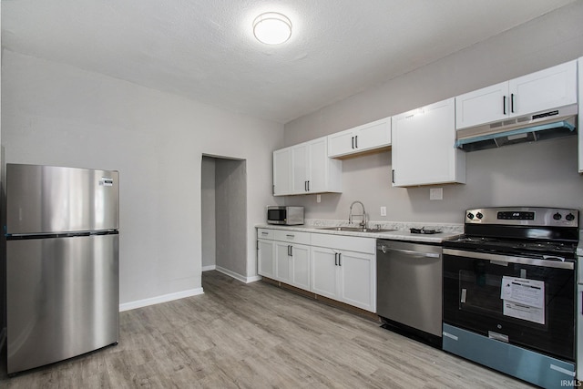 kitchen with sink, light hardwood / wood-style flooring, white cabinetry, and stainless steel appliances