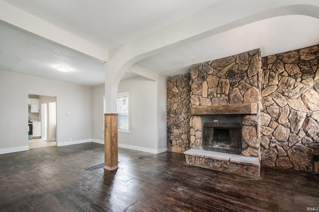 unfurnished living room featuring a stone fireplace and hardwood / wood-style flooring