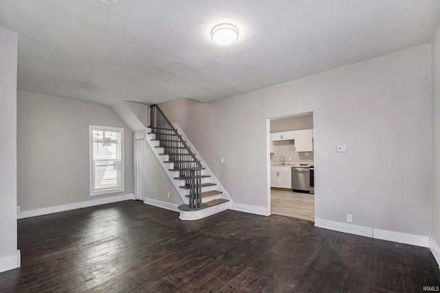 unfurnished room featuring wood-type flooring and sink