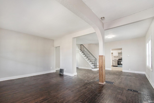 basement with dark hardwood / wood-style floors