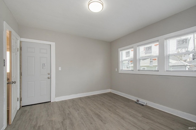 spare room with hardwood / wood-style floors