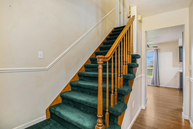 stairs featuring wood-type flooring