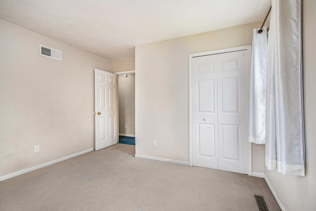 unfurnished bedroom with a closet and carpet floors