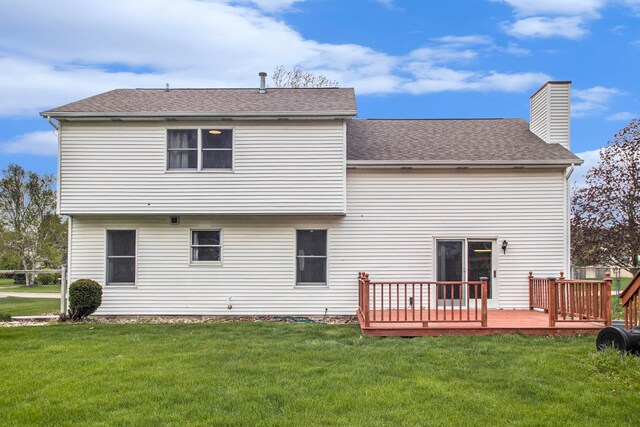 rear view of property with a deck and a yard