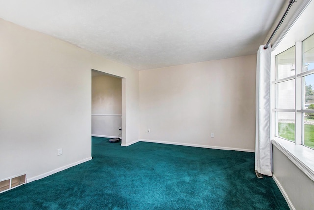 empty room featuring dark carpet