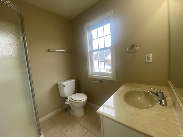 bathroom featuring tile floors, plenty of natural light, vanity, and toilet