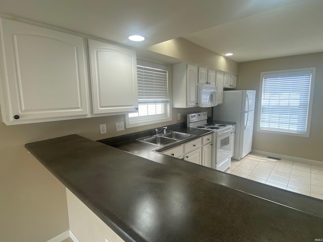 kitchen featuring white appliances, sink, light tile floors, and white cabinetry