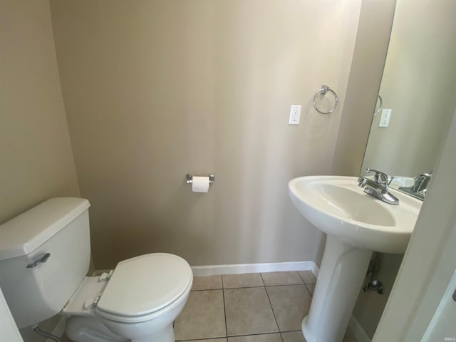 bathroom featuring toilet and tile floors