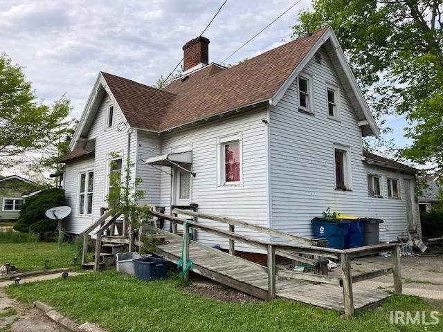 back of property with a wooden deck