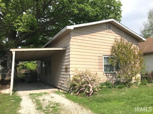 view of side of home featuring a carport