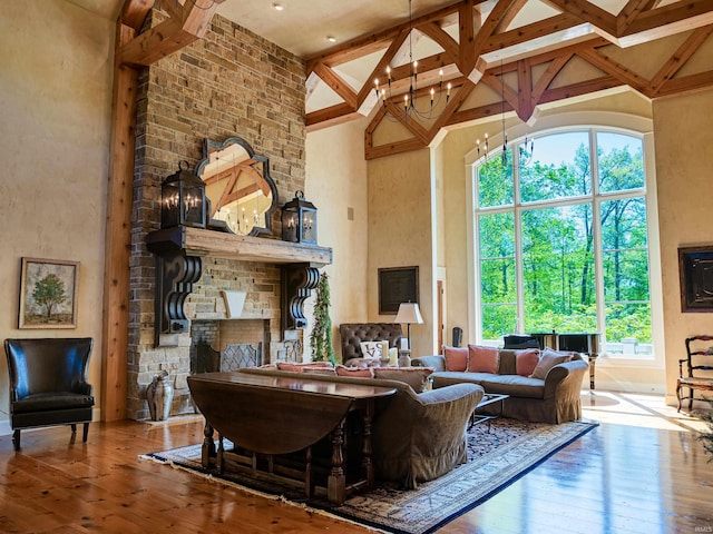 living room with high vaulted ceiling, hardwood / wood-style floors, and a wealth of natural light