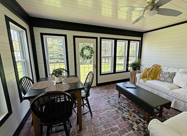 sunroom / solarium featuring ceiling fan and a healthy amount of sunlight