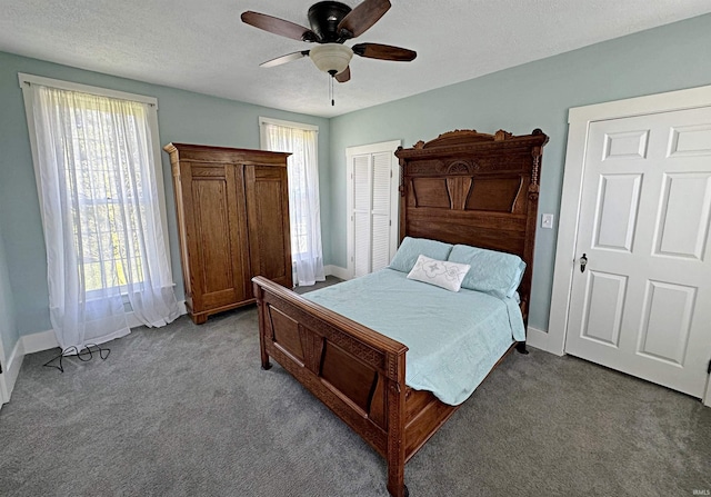 bedroom with a closet, a textured ceiling, carpet floors, and ceiling fan