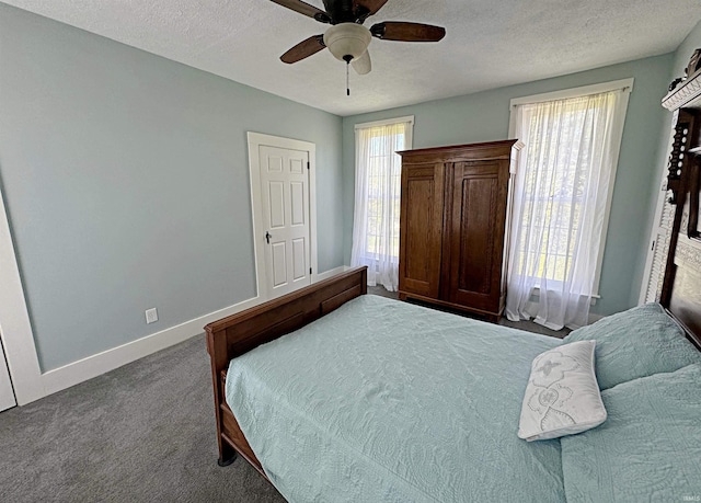 carpeted bedroom with ceiling fan and a textured ceiling