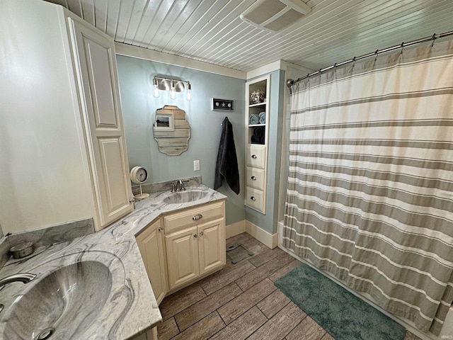 bathroom with wood ceiling, dual vanity, and hardwood / wood-style floors