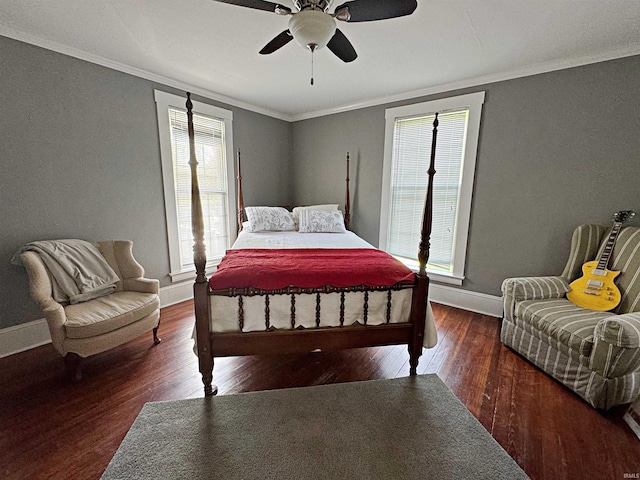 bedroom with crown molding, dark wood-type flooring, and ceiling fan