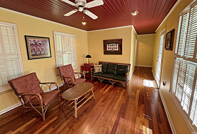 living area featuring ornamental molding, ceiling fan, hardwood / wood-style floors, and wooden ceiling