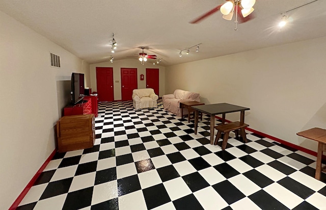 interior space with vaulted ceiling, ceiling fan, track lighting, and tile floors