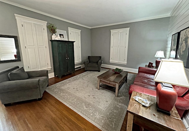 living room with dark hardwood / wood-style flooring and ornamental molding