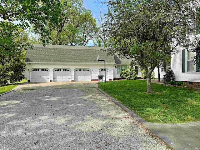 view of front facade with a garage and a front lawn