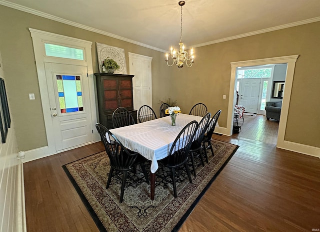 dining room with an inviting chandelier, crown molding, and dark wood-type flooring