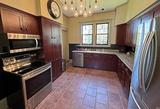 kitchen featuring decorative light fixtures, stainless steel appliances, sink, a notable chandelier, and tile floors