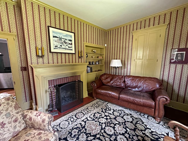 living room with ornamental molding and a fireplace