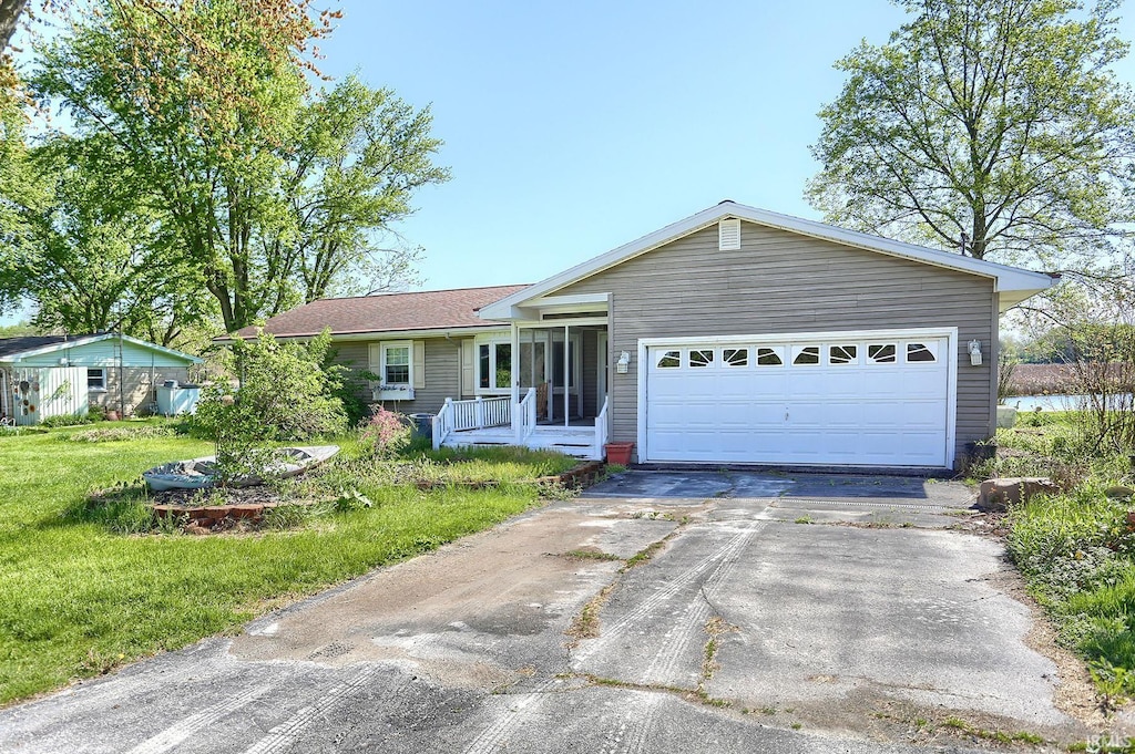 ranch-style home with a garage and a front yard