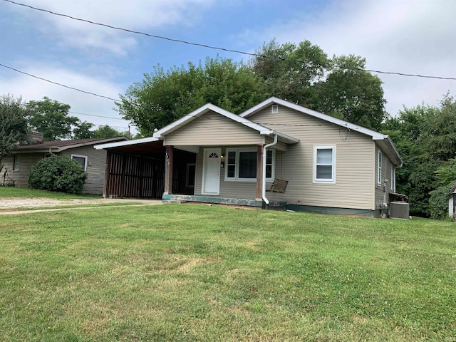 view of front facade featuring central AC, a porch, a carport, and a front lawn