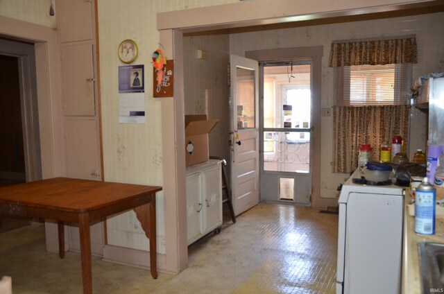 kitchen with white cabinetry and light tile floors