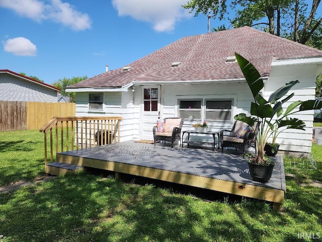 rear view of house featuring a yard and a wooden deck