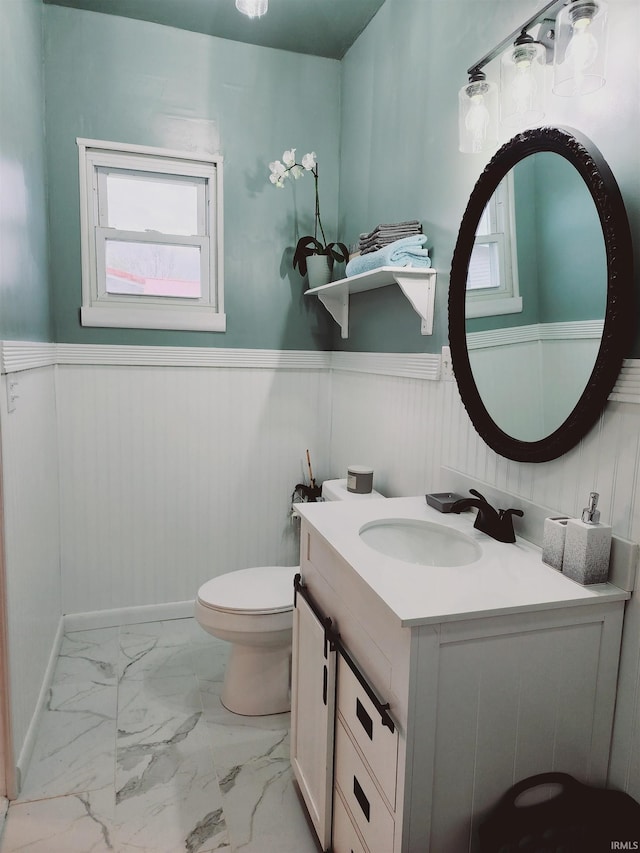 bathroom featuring vanity, tile floors, and toilet