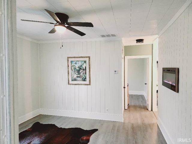 spare room featuring light hardwood / wood-style floors and ceiling fan