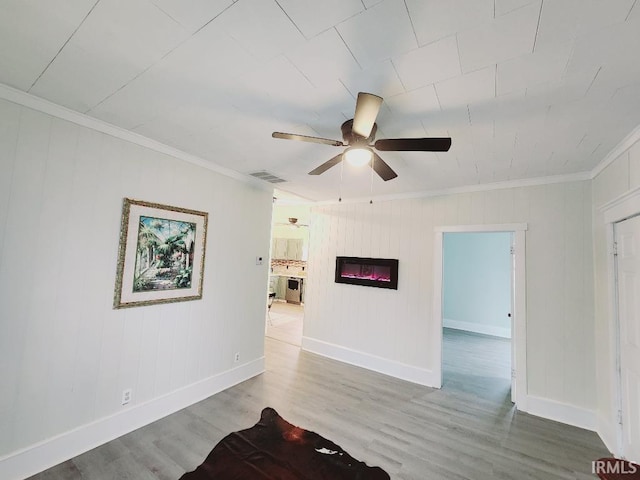 unfurnished living room featuring crown molding, wood-type flooring, and ceiling fan