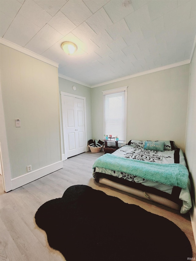 bedroom featuring light hardwood / wood-style flooring and ornamental molding