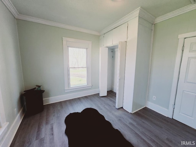 unfurnished bedroom featuring wood-type flooring and crown molding