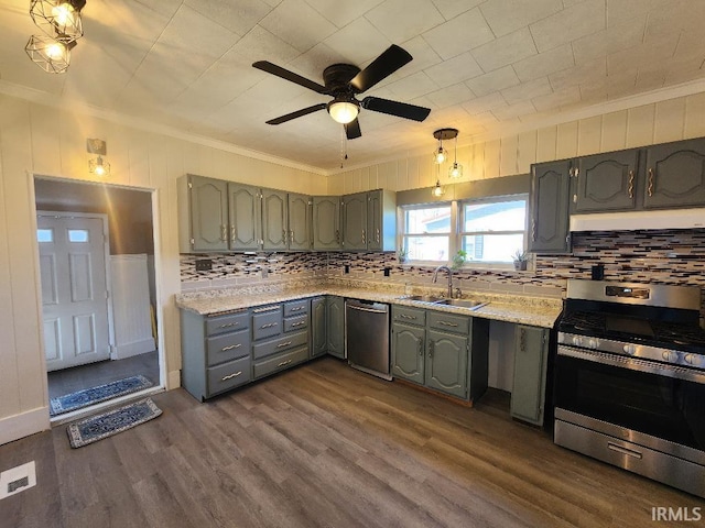 kitchen with dark hardwood / wood-style floors, tasteful backsplash, stainless steel appliances, and ornamental molding