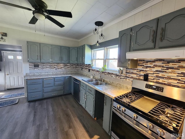 kitchen featuring tasteful backsplash, appliances with stainless steel finishes, dark wood-type flooring, and sink