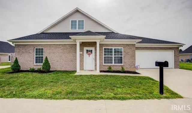 view of front of house featuring a garage and a front lawn