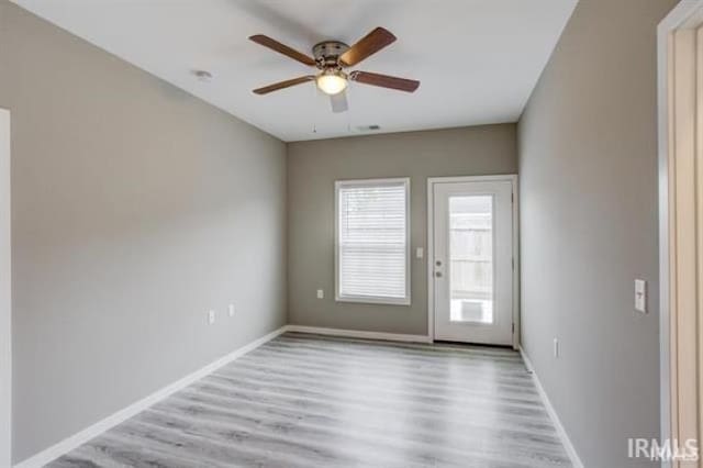 unfurnished room with ceiling fan and light wood-type flooring