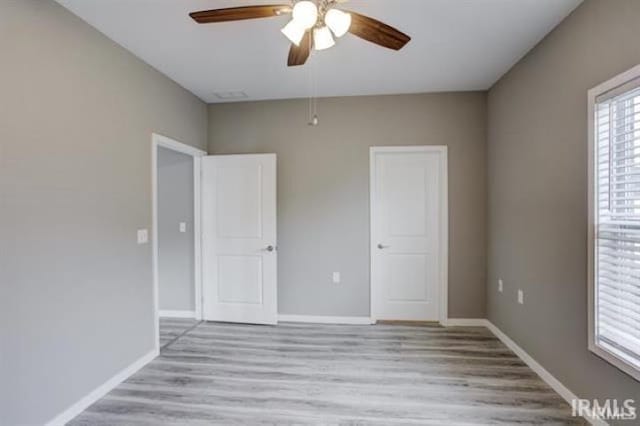 unfurnished bedroom featuring ceiling fan and light wood-type flooring