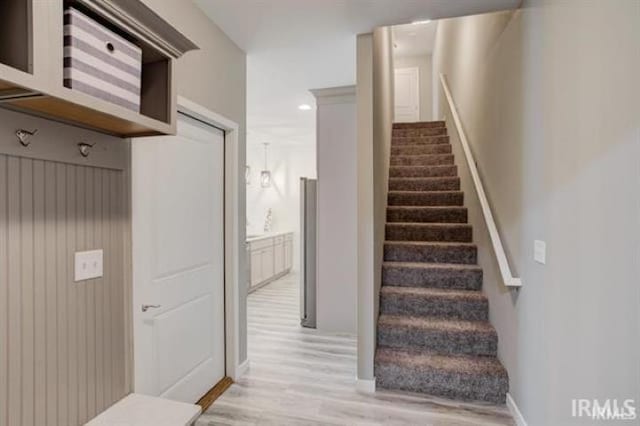 stairs featuring hardwood / wood-style floors