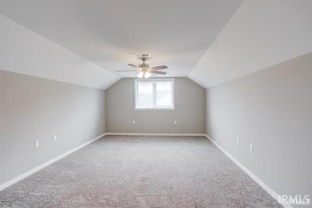 additional living space featuring lofted ceiling, carpet floors, and ceiling fan