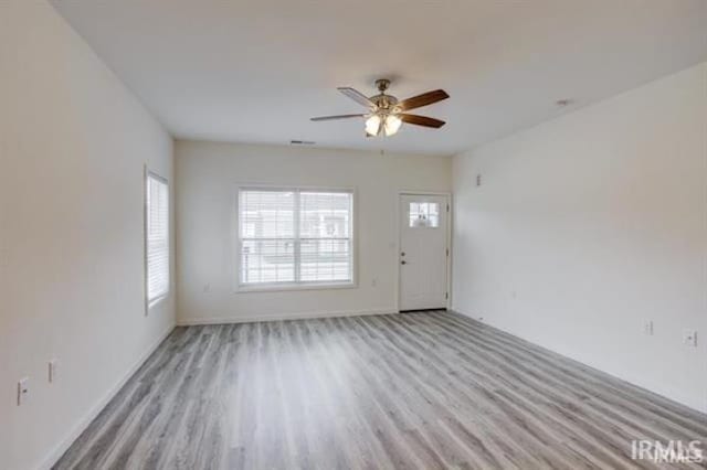 unfurnished room featuring light hardwood / wood-style flooring and ceiling fan