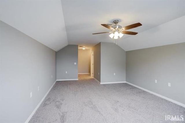 additional living space featuring lofted ceiling, light colored carpet, and ceiling fan